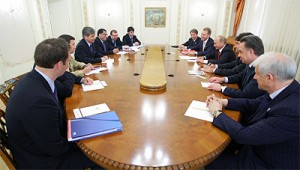 Men Sitting Around Long Oval Boardroom Table, File Photo of FIFA Officials Meeting with Vladmir Putin