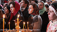 Russian Orthodox Believers Holding Candles at Cathedral at Christmas