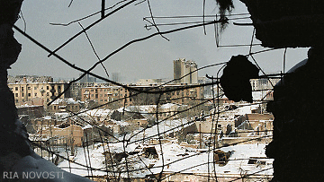 File Photo of Grozny, Looking out of Building Through Damaged Wall