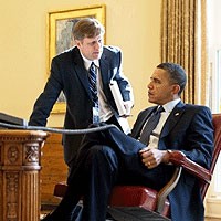File Photo of Barack Obama Sitting at Desk with Mike McFaul Standing Next to Him Facing Him