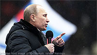 File Photo of Vladimir Putin at Outdoor Rally with Microphone in Hand and Heavy Coat