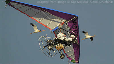 File Photo of Vladimir Putin and Pilot in Hang Glider Airborne Next to Flying Cranes