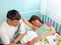 File Photo of Russian Expectant Couple with Mother in Hospital Bed