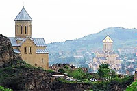 Tblisi, Georgia, File Photo with Building with Tower on Hillside and City Buildings in Valley in Distance