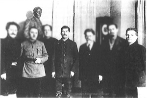 File Photo of Joseph Stalin and Sergei Kirov as Part of Group of Five, Next to Bust of Lenin, with Faces of Other Attendees Partially Blurred