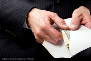Hand Pulling Cash from Envelope