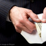 Hand Pulling Cash from Envelope