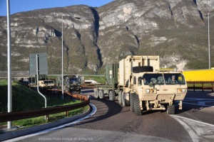 U.S. Military Convoy Headed to Ukraine, On Highway Near Mountains or Cliffs