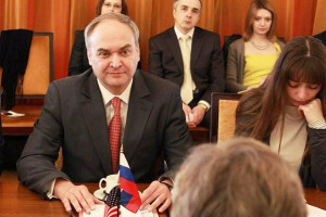Anatoly Antonov and Others Facing U.S. Official with U.S. and Russian Flags on Table