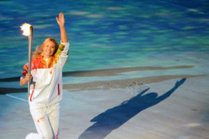File Photo of Maria Sharapov Carrying Olympic Torch and Waving at Sochi
