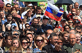File Photo of Crowd in Russia Including Person Waving Russian Flag with Eagle