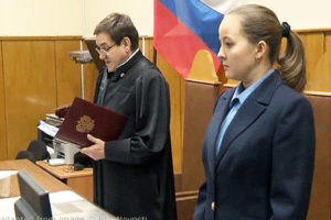 File Photo of Judge and Clerk in Russian Court, with Russian Flag Behind Bench