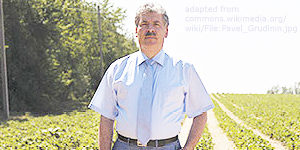 File Photo of Pavel Grudinin in a Farm Field, adapted from wikimedia commons image attributed to user Kelatrat at https://commons.wikimedia.org/wiki/File:Pavel_Grudinin.jpg