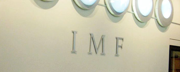 File Photo of IMF Acronym on Wall Below Row of Circular Lights, adapted from image at state.gov by Steven C. Welsh :: www.stevencwelsh.com :: www.stevencwelsh.info
