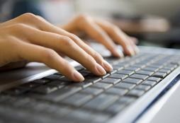 File Photo of Woman's Hands Typing on Computer Keyboard, adapted from image at fbi.gov