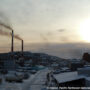 File Photo of Smokestacks Spewing Pollution in Murmansk, Russia, at twilight or before dawn, adapted from image at pnnl.gov with photo credit to N. Kholod