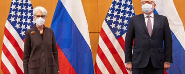 File Photo of Wendy Sherman and Sergei Ryabkov Standing In Front of U.S. and Russian Flags, adapted from image at state.gov