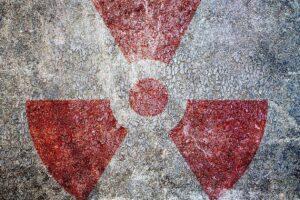 Radioactivity Symbol Against Mottled Metallic Background, adapted from image at ready.gov