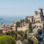 File Photo of Towers of San Marino on Mountain Top, adapted from state.gov photo